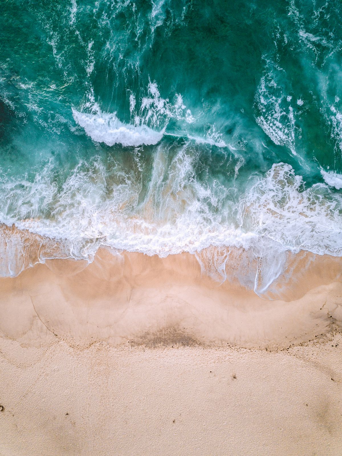 Waves reaching a sandy shore