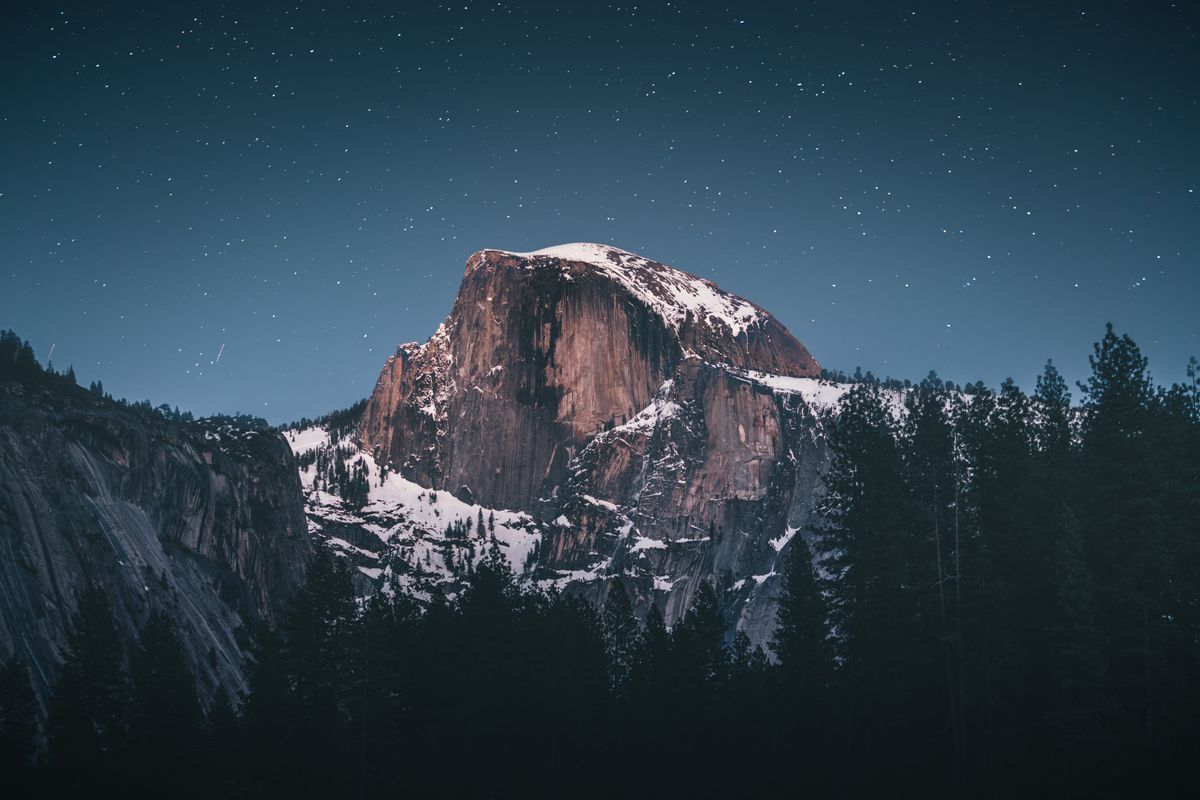 A granite mountain landscape with forest